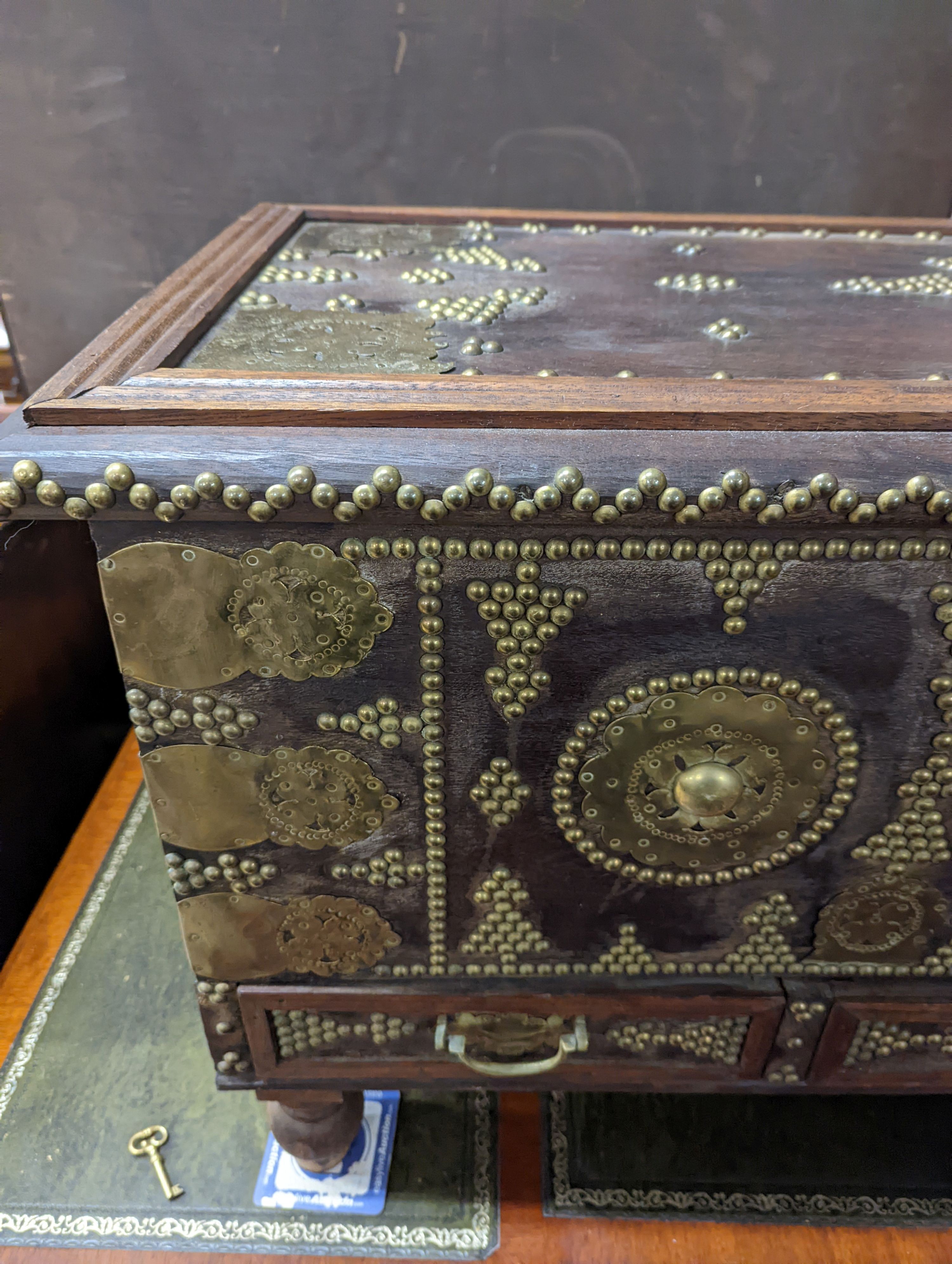 An Eastern brass mounted and studded hardwood trunk, length 113cm, depth 48cm, height 60cm